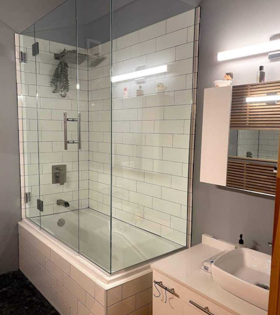 This picture is taken in a modern, elegant bathroom with a frameless glass shower. If you are looking for a shower door replacement company in Manchester, NH to upgrade your shower then Pane Free Glass can help.