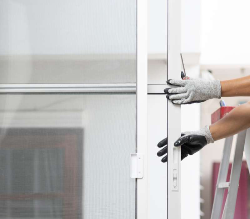 Image of one of our contractors repairing a sliding glass door for a property in New Hampshire. 